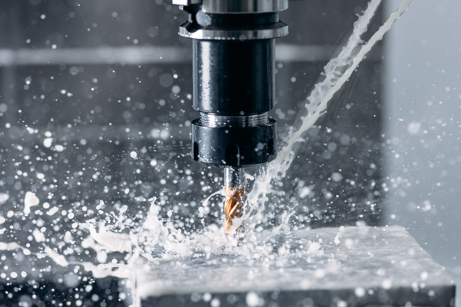 Working closeup CNC turning cutting metal Industry machine iron tools with splash water.